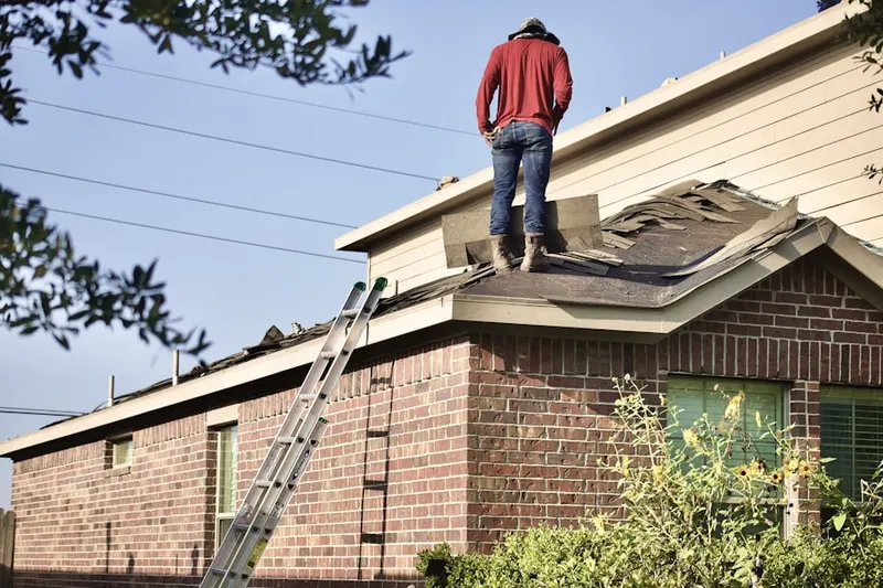 Professional roofer working on a residential roof in Hembree Hills